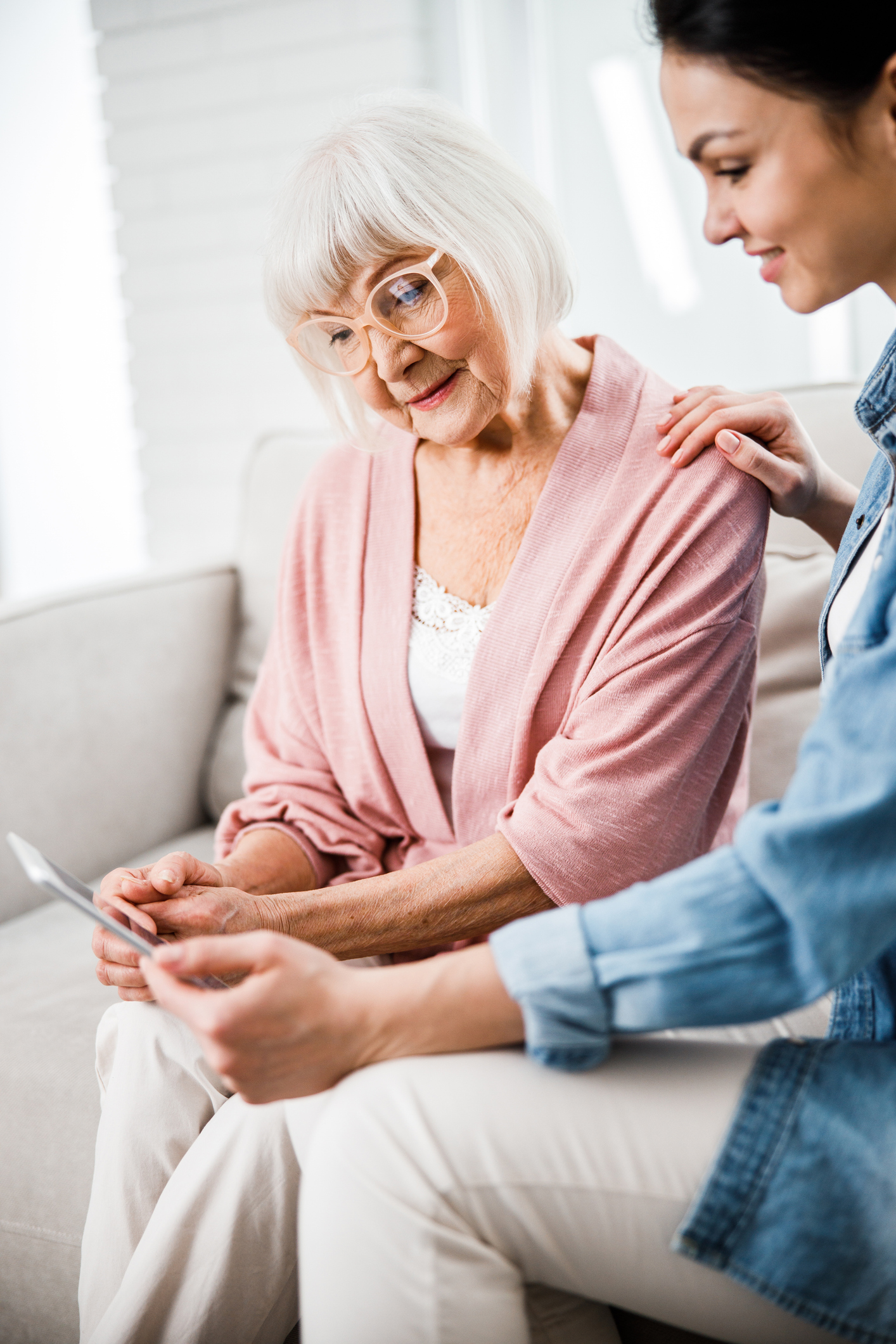 Old woman and her daughter talking with doctor through video call
