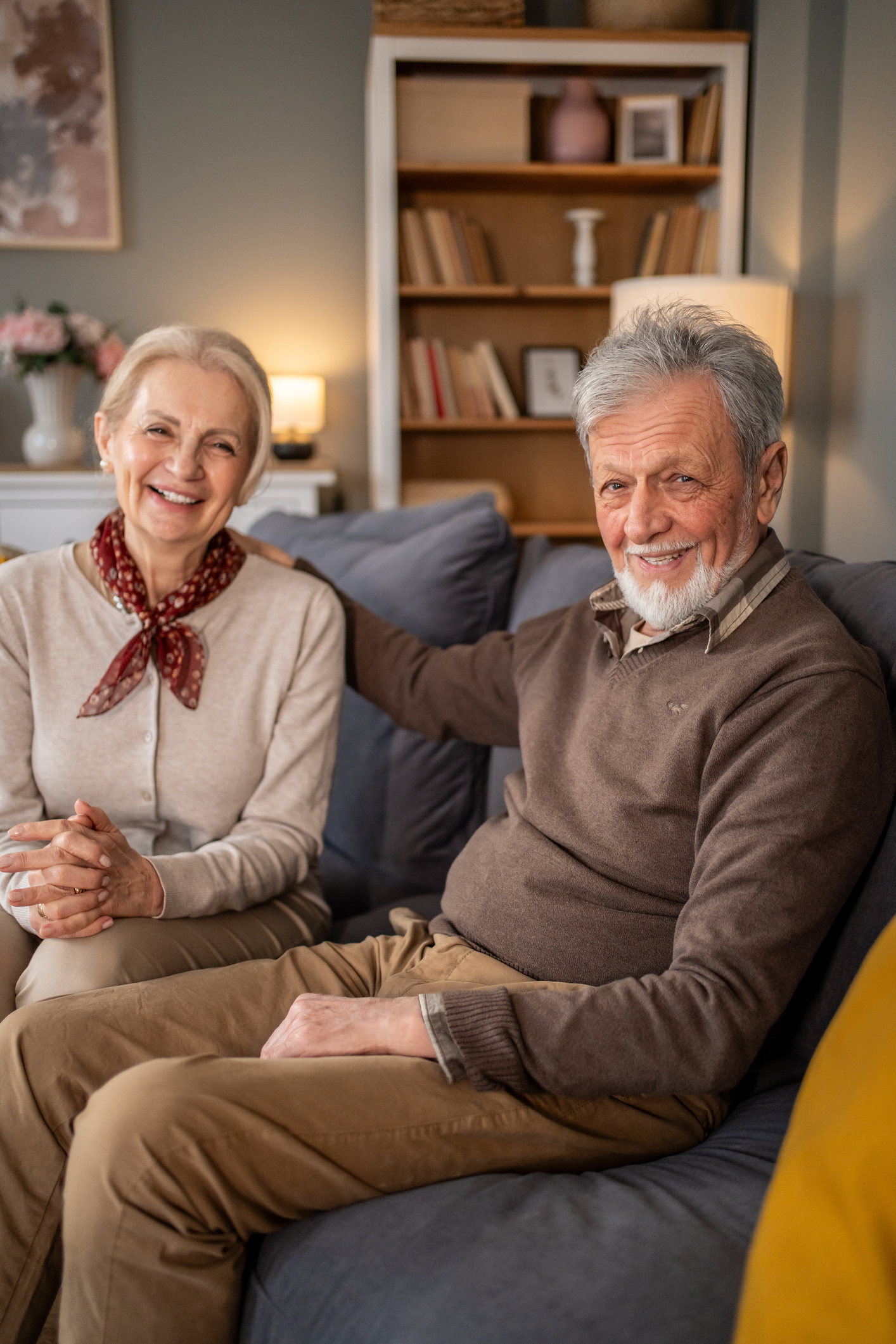 Happy senior couple relaxing on sofa at home