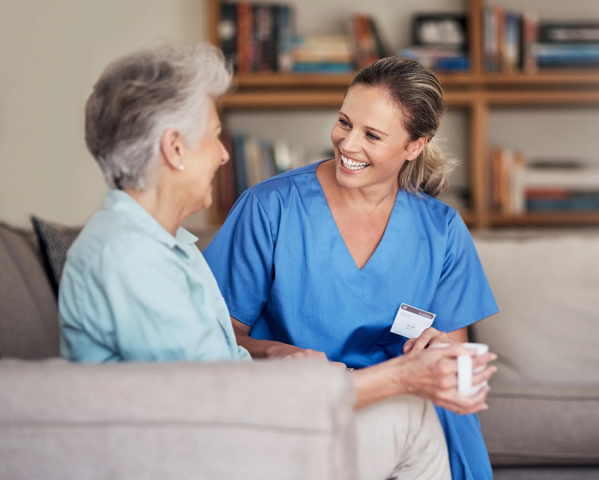 Assisted living in Conroe TX – senior woman smiling while reading in a cozy home setting